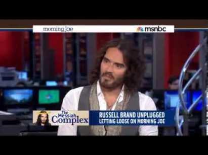MOCKING THE MEDIA COMPLEX: Comedian Russell Brand feigned reading the news as a way to highlight the trivialization major issues by the news media.